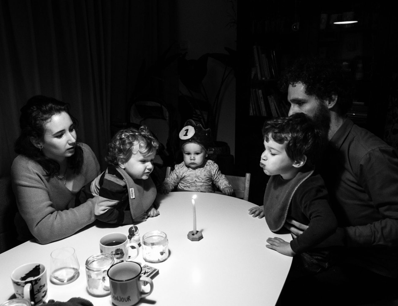 blowing out a birthday candle. family of five