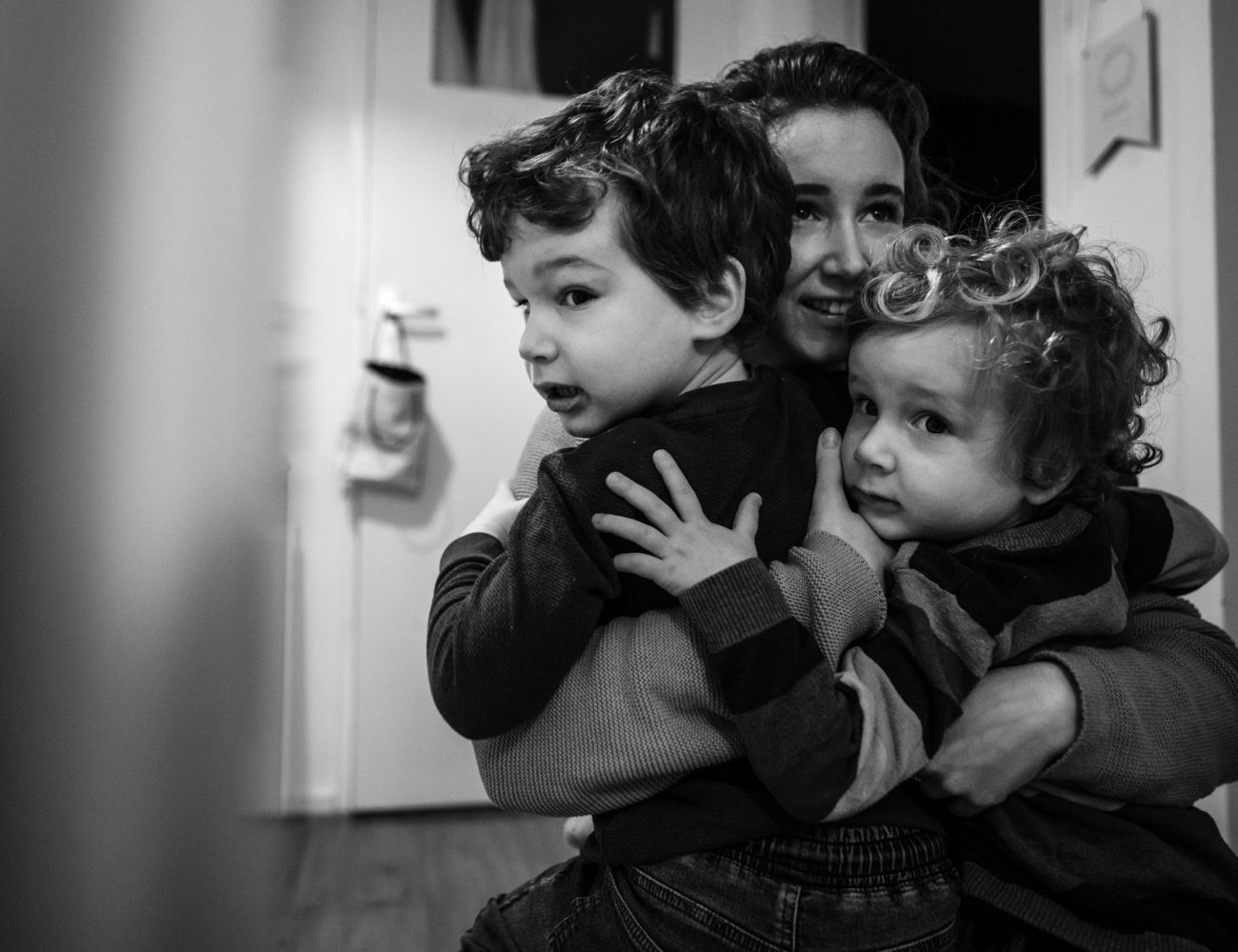 mother and sons cuddle